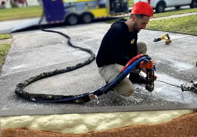 Injecting polyurethane foam under a driveway slab